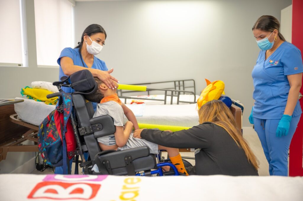 Therapist guiding a child through physical therapy exercises at Peek A Boo Pediatric Care in Hollywood, FL